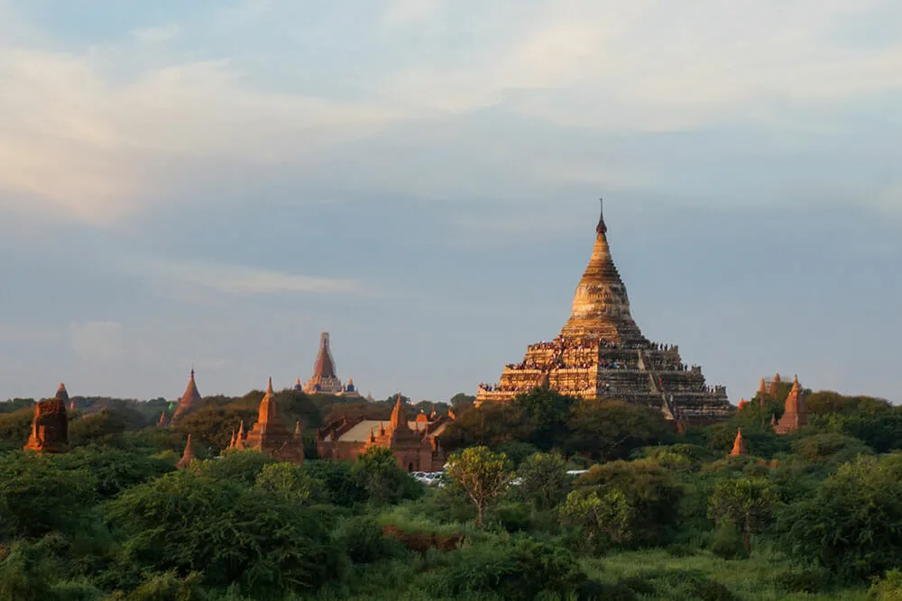 Shwesandaw Pagoda Bagan Myanmar Burma surrounded by lush green trees under blue skies