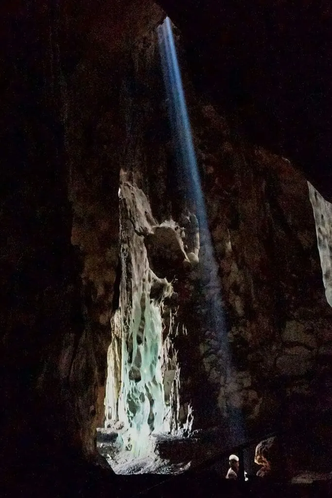 Ray of light shinning through a hole in the ceiling of a cave