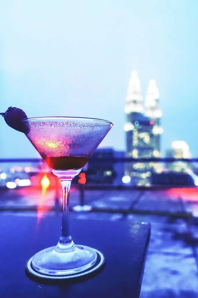 Cocktail glass with strawberry with Petronas Towers in the background