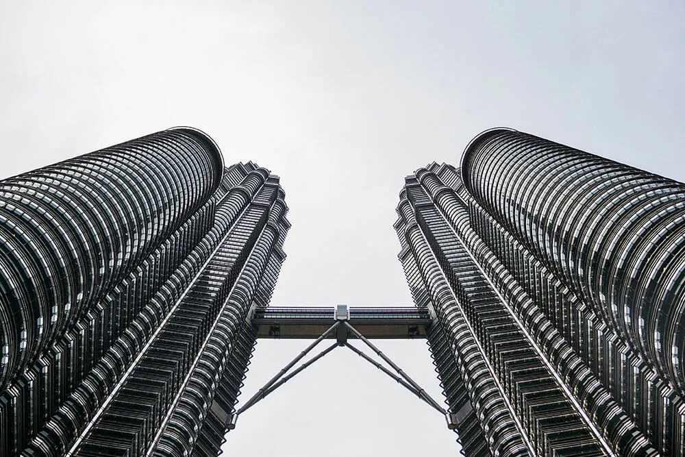 Symmetrical look up of Petronas Twin Towers with Sky Bridge joining them