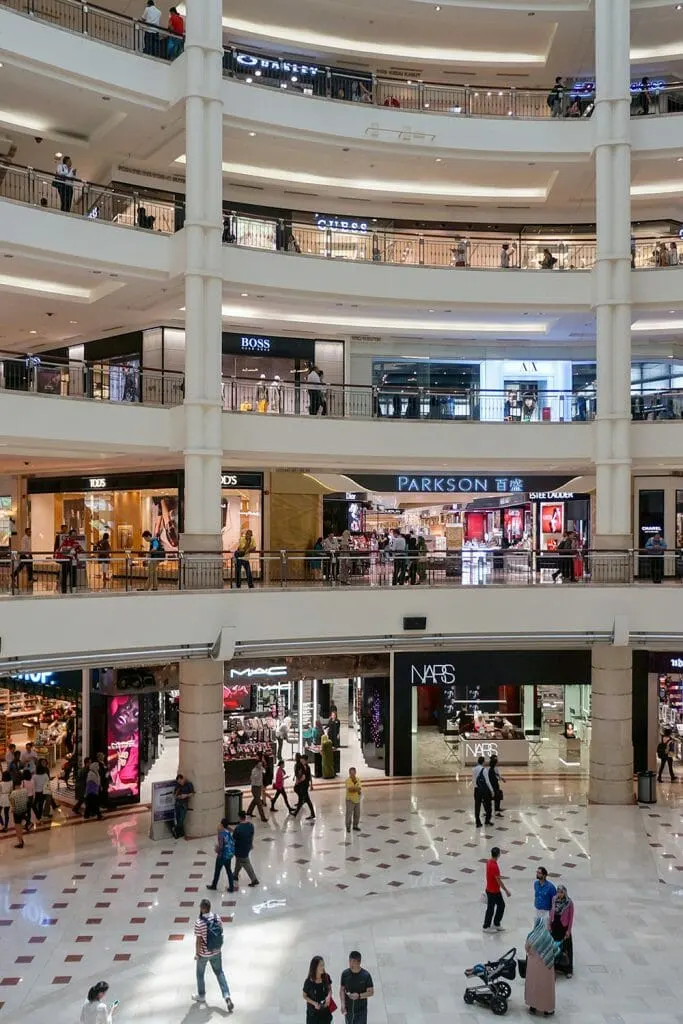 Atrium of a 4 floor shopping centre with people walking around