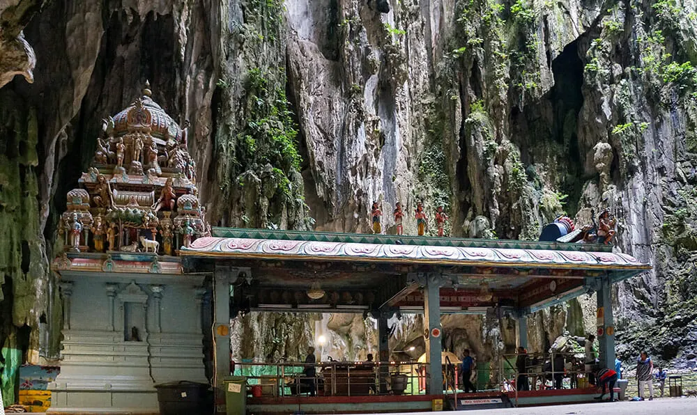 Hindu temple with a rock face behind it