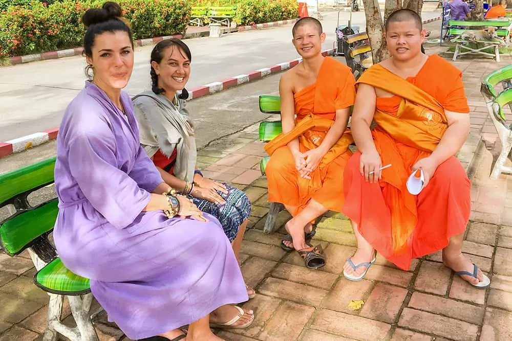 Two women talking to two buddhist monks in Chiang Mai Thailand