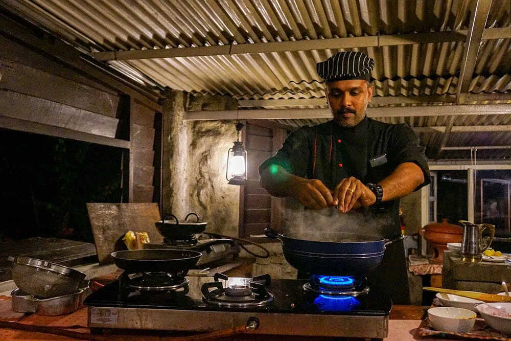 Chef giving a cooking demonstration of Kerala fish curry at Windermere Estate Munnar India - #munnar #kerala #india