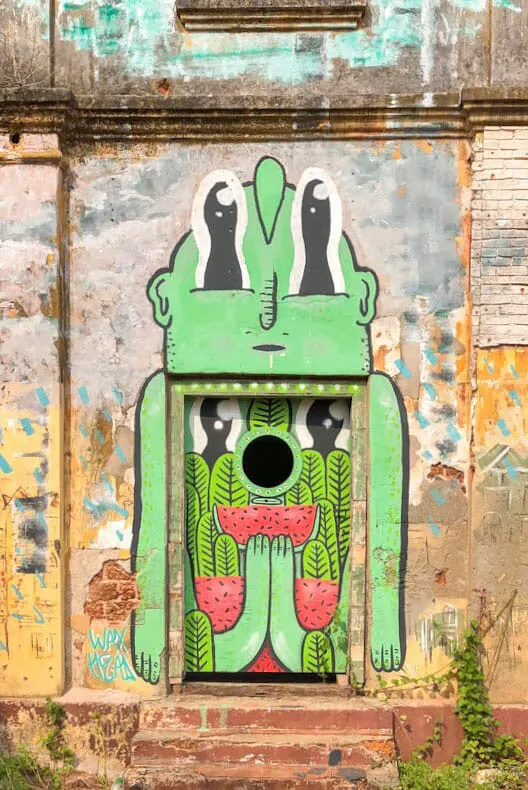 Street art piece around a door in an abandoned building in Kochi