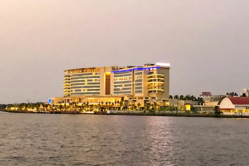 The Grand Hyatt Kochi Bolgatty Hotel at dusk seen from a boat