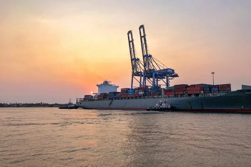 Sunset over a cargo ship moored in Kochi