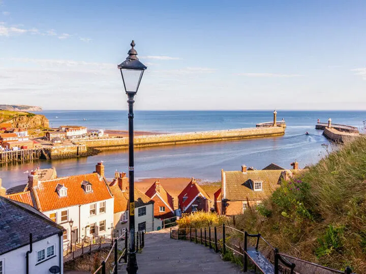 Whitby is a great day trip from York. Cute street going down into the harbour with street lamp