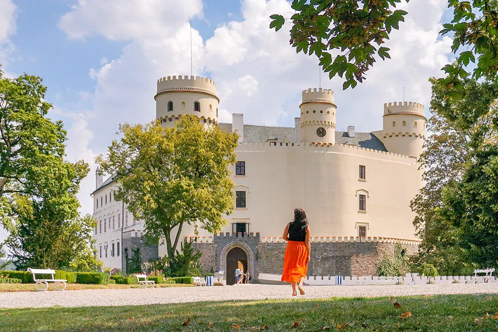 Me walking towards a fortress-like white castle with three towers