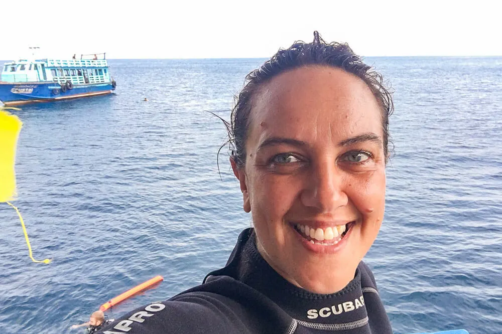 Me smiling after a dive off Koh Tao, one of the 10 best things to do in Thailand