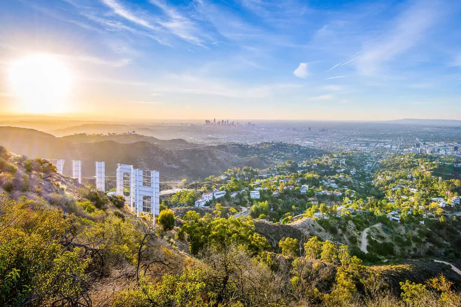 View of Los Angeles from the top of the hill with part of the back of the Hollywood sign visible