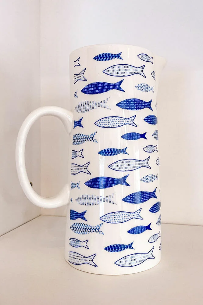 Tall ceramic jug with handle with a print of blue and white pilchards