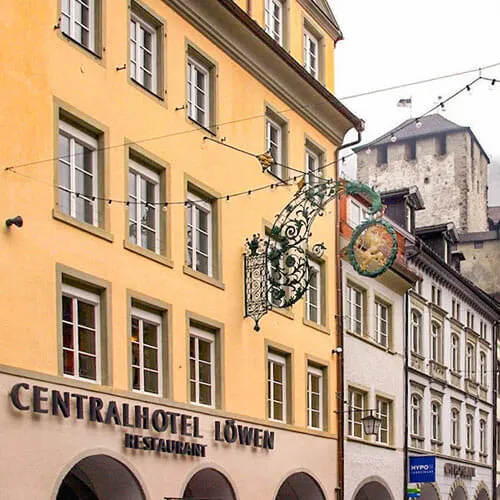 Medieval three storey hotel painted yellow with Central Hotel Lowen lettering on the fa&ccedil;ade
