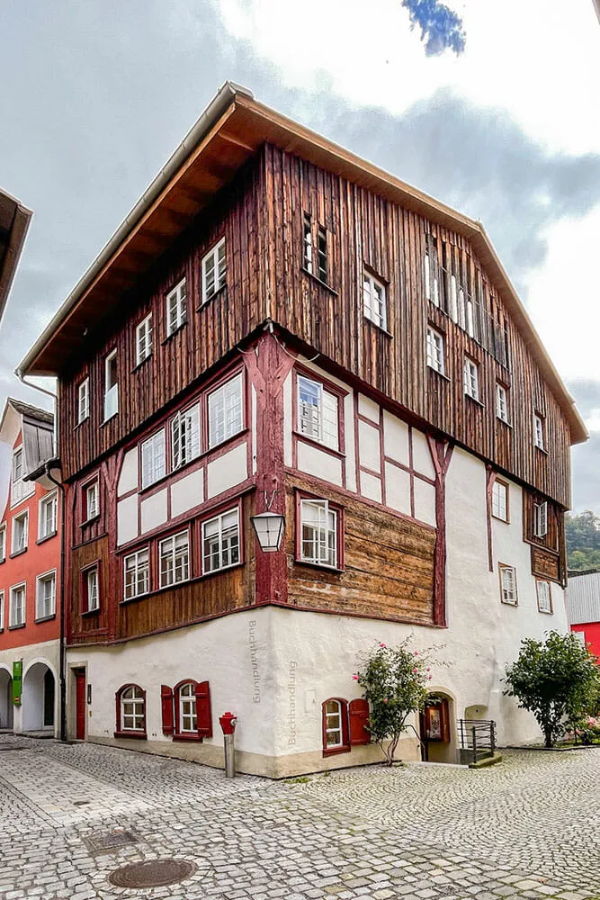 Three storey Medieval timber house with red wooden windows