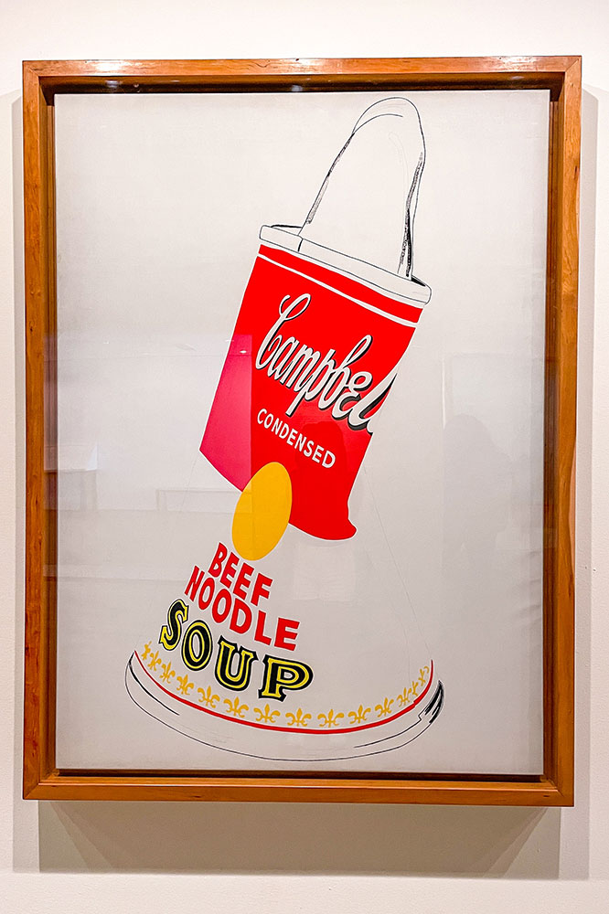 A Campbell Beef Noodle Soup framed art work with a glass case.