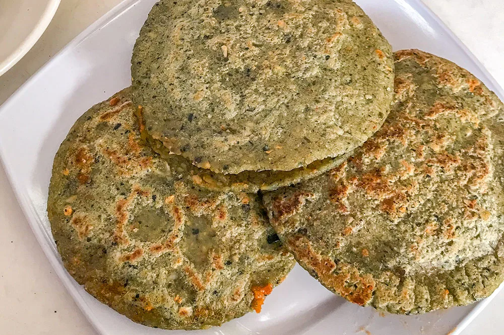 3 circular tortillas with pockets served on a white square plate